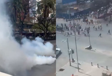 A file photo of police officers lobbing tear gas at business owners in Nairobi CBD.